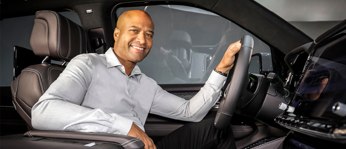 Alumnus and global president of product design at Fiat Chrysler Automobiles Ralph GIlles sits in the driver seat of a car he's designed.