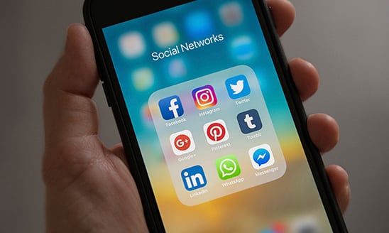 A view of a smartphone with social networking and social media apps on display.