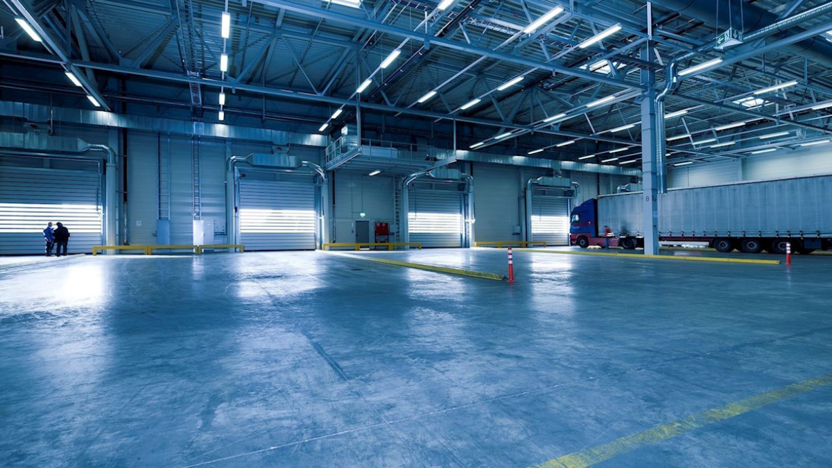 The wide floor of an empty warehouse
