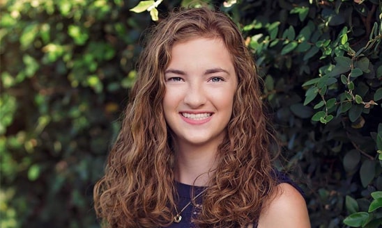 Junior Courtney Palkowski against a backdrop of greenery