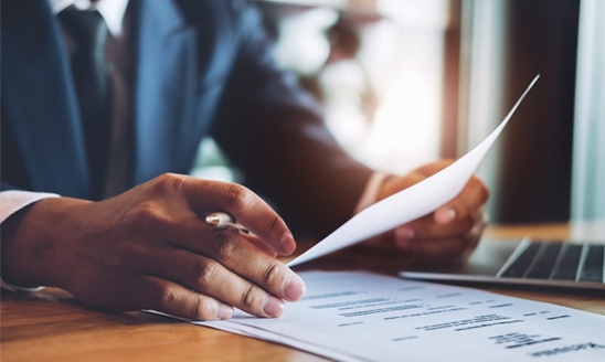 Text: Broad College of Business, Image: An overhead view of the Minskoff Pavilion filled with people and a Spartan helmet logo.