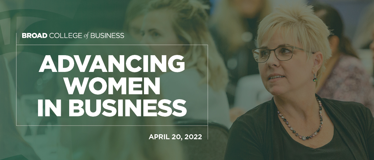 A woman in the audience pays attention to a speaker out of frame