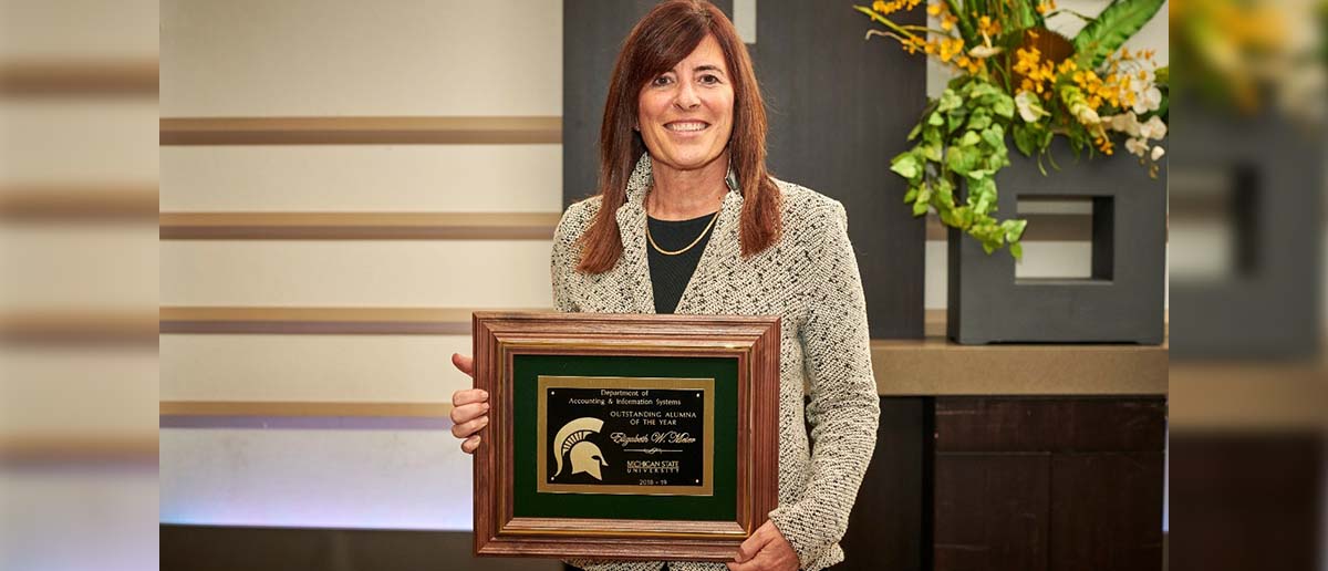 Betsy Meter holds her framed award