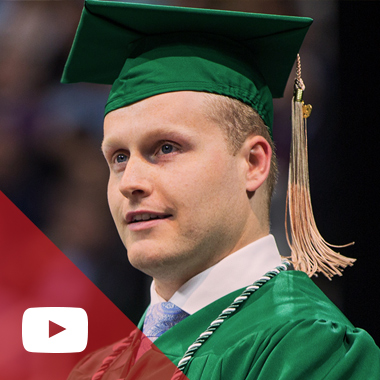 Tim Sharky wears his Spartan green commencement ceremony cap and gown