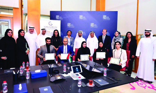A picture of the five Global Master Certificate in Business Analytics participants and the faculty and staff involved through the partnership between MSU and the University of Dubai.