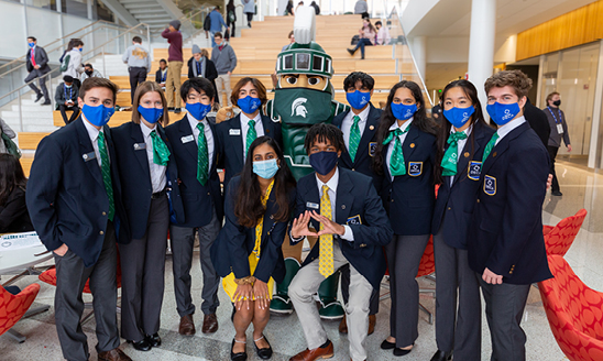 Michigan DECA students pose with Sparty in the Minskoff Pavilion