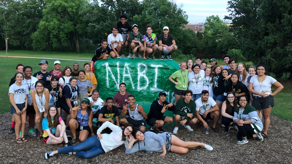 NABI 2018 participants pose around the Rock, which has been painted to read 'NABI'