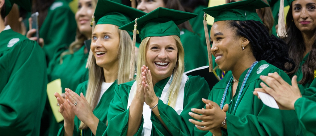 Several spring 2018 graduates clap at commencement