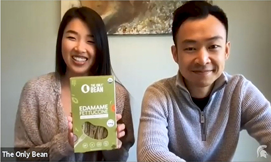 Kristine Yang and Brian Lai showing a box of The Only Bean Edamame Fettucine