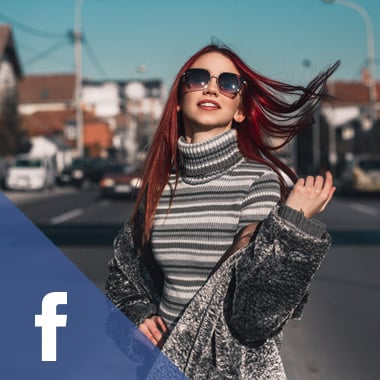 Young woman standing in an urban street swings her hair
