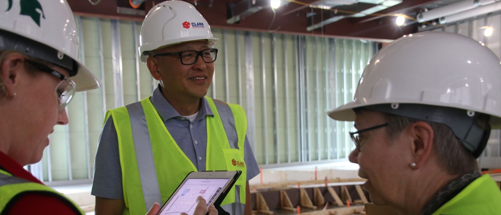 Frank Yang, center, president of INCODEL Michigan LLC of Romulus, Mich., and Lucy Maillette, right, the college’s director of new academic initiatives and former EMBA director, take a hard hat tour of the Broad College Business Pavilion work site recently.