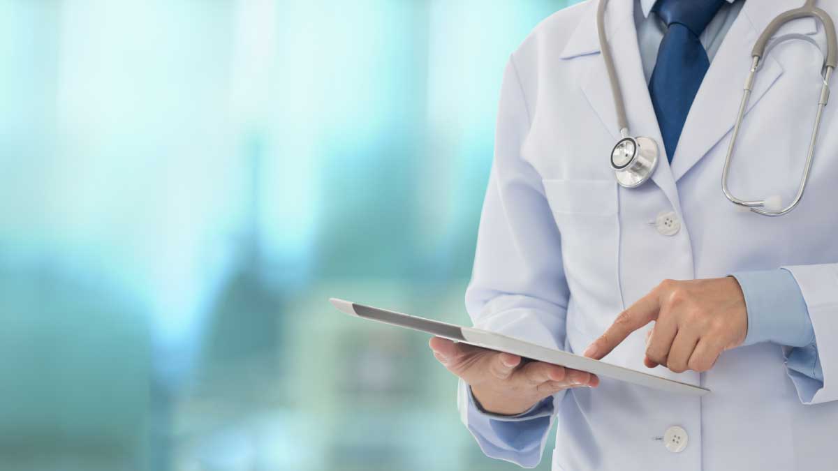Doctor looks at data on tablet