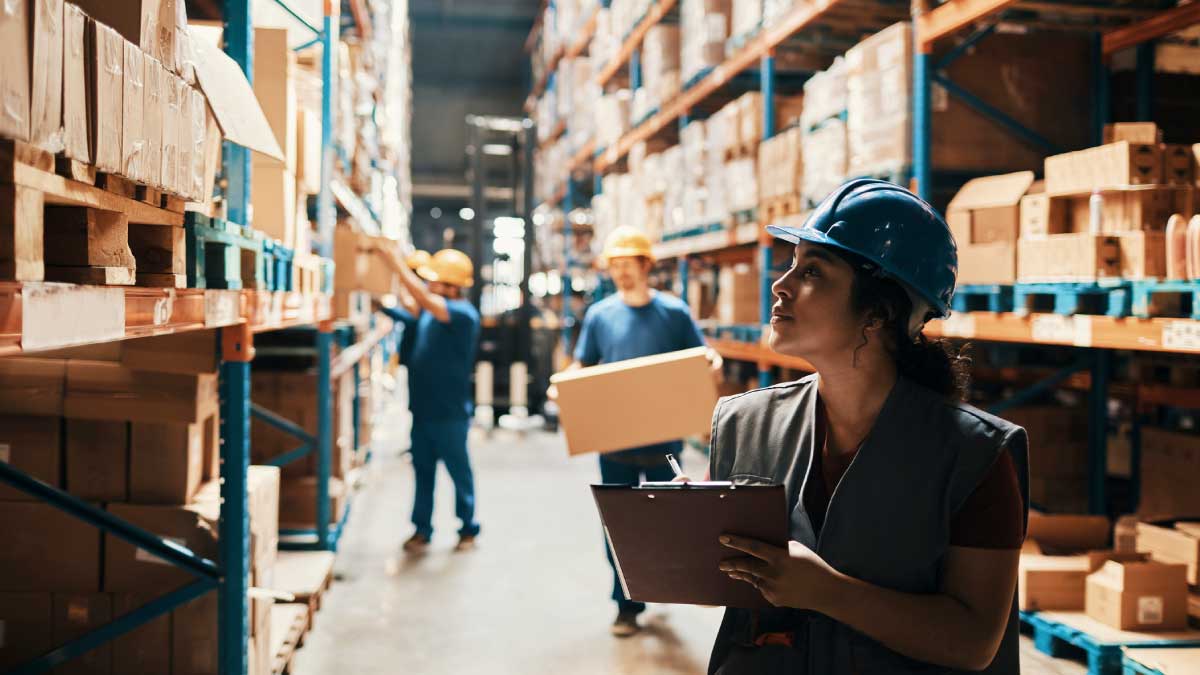 Employees work inside a large warehouse